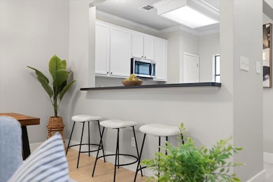 Kitchen with stainless steel microwave, a breakfa