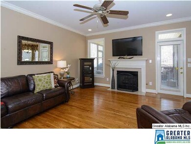 Spacious living room with hardwoods, crown molding