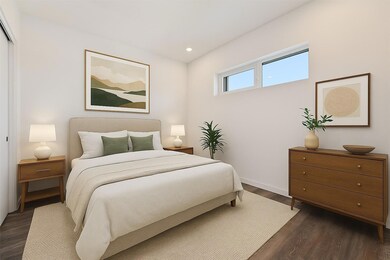 Bedroom with dark wood-style flooring and recesse