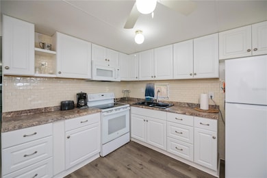 Spacious updated kitchen with new cabinetry and counters.
