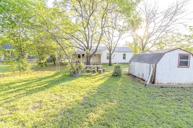 View of yard featuring a storage shed and an outbu