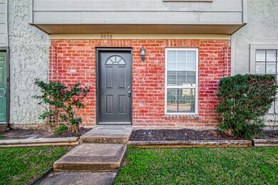 The red brick and wood facade of this home creates