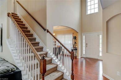 A grand 2 story foyer with arched entries to the formal dining & living rooms.