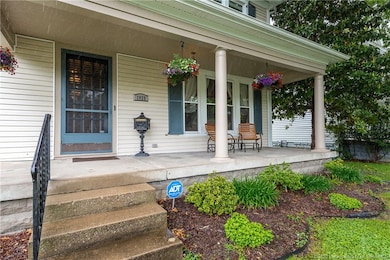Large covered porch and beautiful original doors!