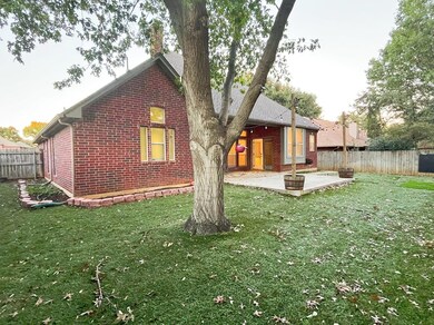Back of house with a yard and a patio area