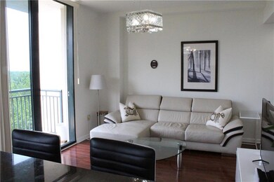 Living room with wood finished floors and a chandelier