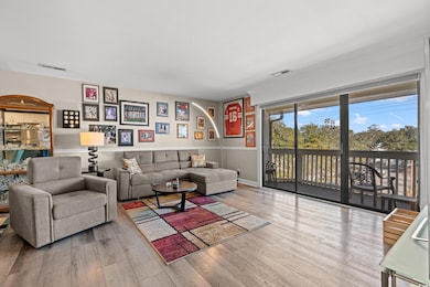 Living room with light hardwood / wood-style floors