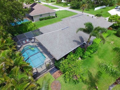 Aerial view of house/pool area and lush yard