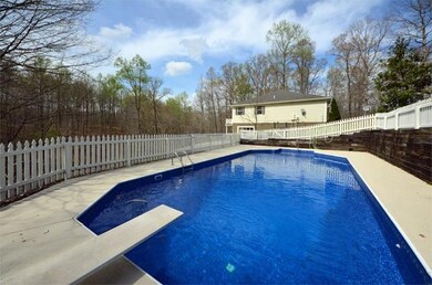 In-ground pool has storage building and new liner.