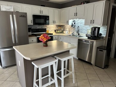 Kitchen with sink, decorative backsplash, black ap