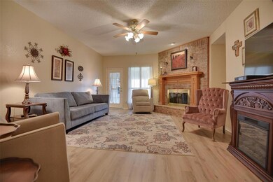 Fresh wood laminate flooring flows through the main living area and updated neutral paint coordinates perfectly.  Light and bright, the family room is sure to be the perfect space for entertaining.  Enjoy the gas log fireplace when the weather is chi