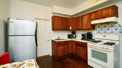 The hardwood floors from the living room flow into