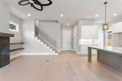 Kitchen with a ceiling fan, white cabinetry, recessed lighting, light countertops, and light wood-style flooring