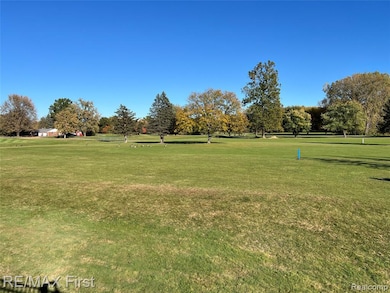 View of property's community featuring a yard