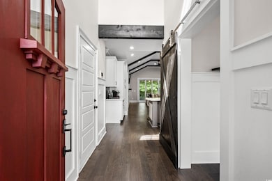 Entrance foyer featuring a barn door, dark wood-ty