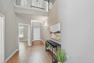 Gorgeous two story entryway with ceramic tile wood
