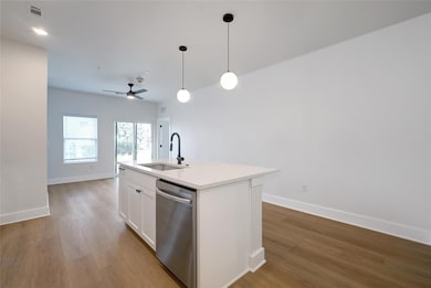 Kitchen with stainless steel dishwasher, a sink, 