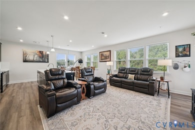 Living area with recessed lighting and light wood-type flooring