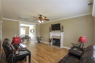 Lining Room w/Hardwood, Crown Moulding & Fireplace