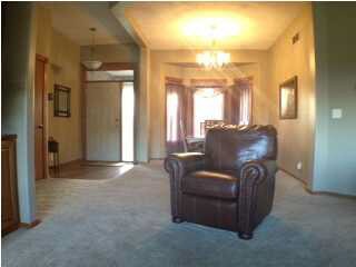 View of entry foyer and formal dining with front b