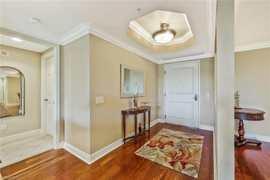 Foyer entrance with baseboards, crown molding, and