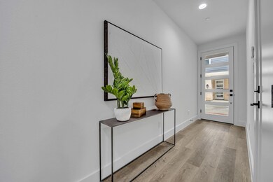 Doorway to outside featuring baseboards, wood fini