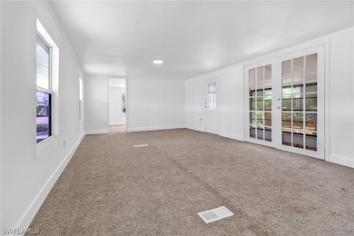 Carpeted empty room with french doors