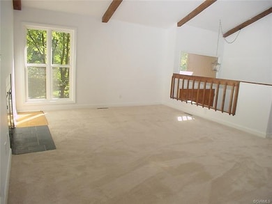 Sunny living room has extra tall windows