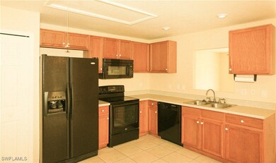 Kitchen featuring brown cabinetry, light counterto
