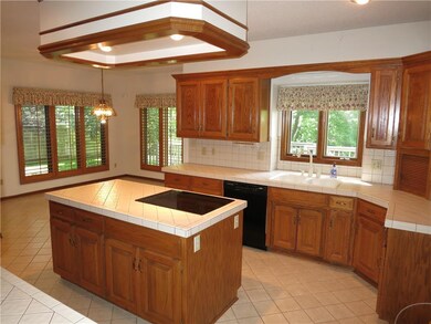 Well lit 13 X 13 chefs kitchen with tile flooring,