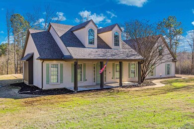 View of front of house with a patio and a front ya