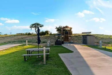 View of community featuring a lawn and a shed