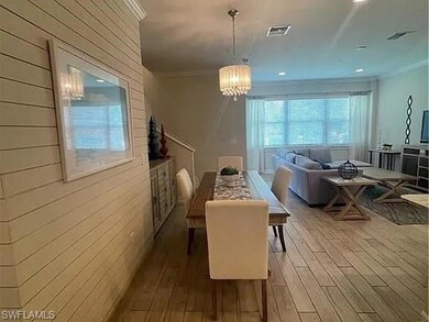 Dining room with a chandelier, crown molding, wood finished floors, and recessed lighting