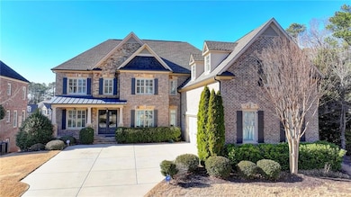 View of front of house featuring driveway, central