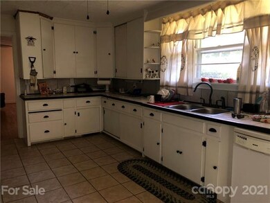 Large country kitchen with ceramic tile flooring