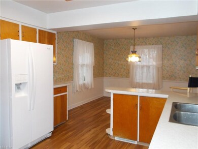 Eating area off of the kitchen with beautiful laminate flooring.