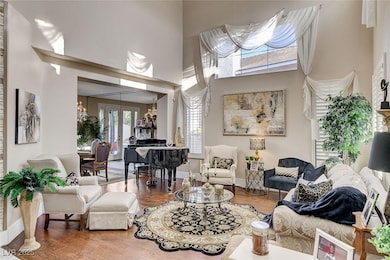 Living area featuring a high ceiling, a notable ch