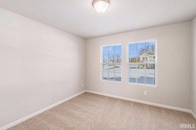The den has ample lighting, French door entry and 