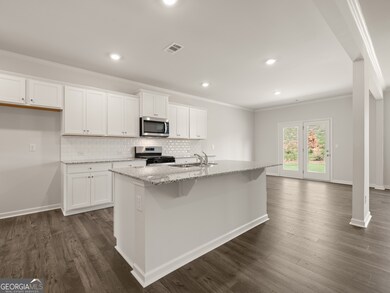 halton floorplan kitchen with a large island for bar seating separating the kitchen from the living room