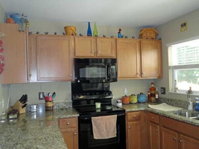 The light colored cabinets and counters really pop with the black apppliances.