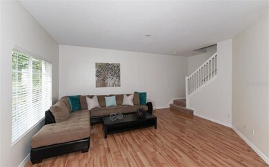 Downstairs to Left: Living Area with carpeted Stai