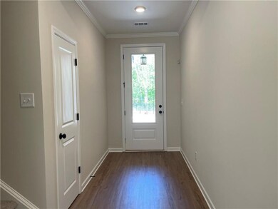 8' Front door, wide foyer with crown molding, coat