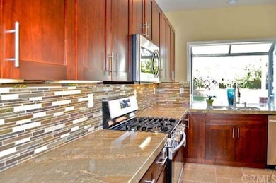 colorful back splash, granite counters, stainless 