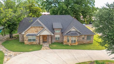 View of front facade with a shingled roof and a front yard