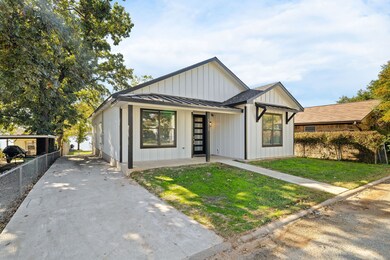 Modern farmhouse style home with a standing seam roof, board and batten siding, and a metal roof