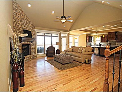 Living Room. Beautiful living area with hardwood flooring and stone fireplace for cold nights