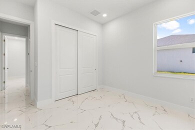 Unfurnished bedroom featuring a closet, marble fin