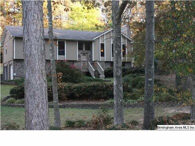 The home sits back from the street on a wooded lot