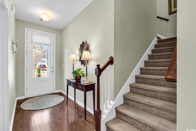 Foyer entrance with hardwood / wood-style floors