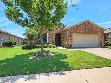 View of front of home with a garage and a front la